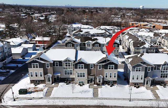 snowy aerial view with a residential view