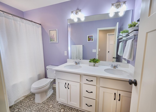 full bathroom featuring a sink, toilet, and double vanity