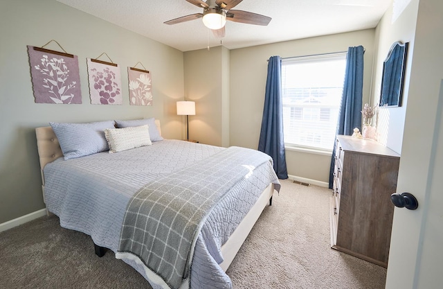 carpeted bedroom with baseboards and a ceiling fan