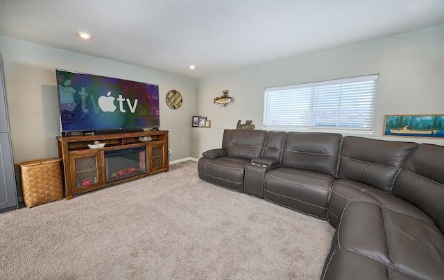 carpeted living area featuring a textured ceiling and baseboards