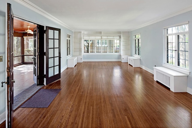 interior space with crown molding, dark wood-style flooring, radiator heating unit, and built in features