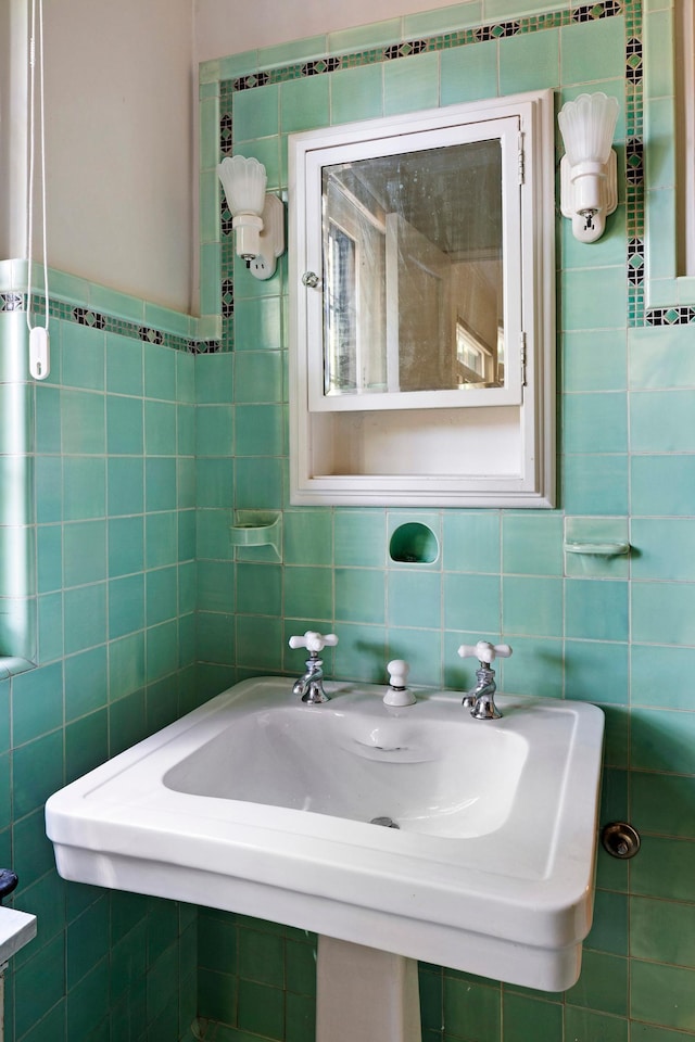 bathroom with a sink and tile walls