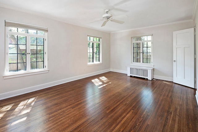 spare room with crown molding, baseboards, dark wood finished floors, and radiator heating unit