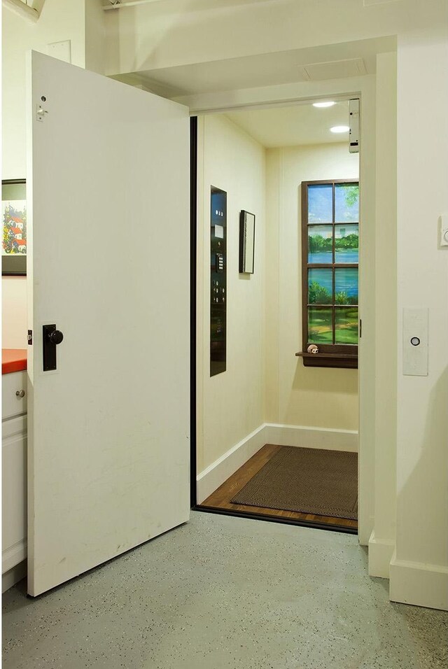 hallway featuring baseboards