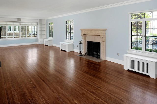 1769 Dupont Ave S Unit 1, Minneapolis, MN 55403 - unfurnished living room with radiator, built in shelves, a tile fireplace, wood finished floors, and baseboards