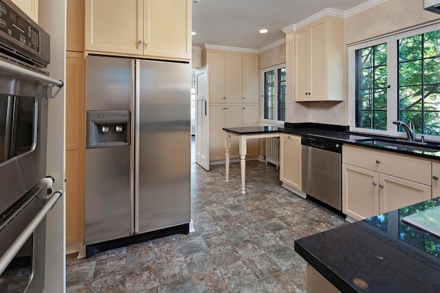 1769 Dupont Ave S Unit 1, Minneapolis, MN 55403 - kitchen with stainless steel appliances, a sink, ornamental molding, stone finish floors, and recessed lighting