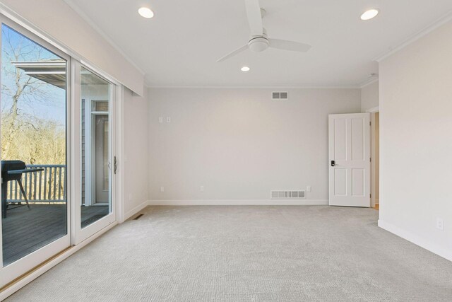 empty room with ornamental molding, visible vents, and a healthy amount of sunlight