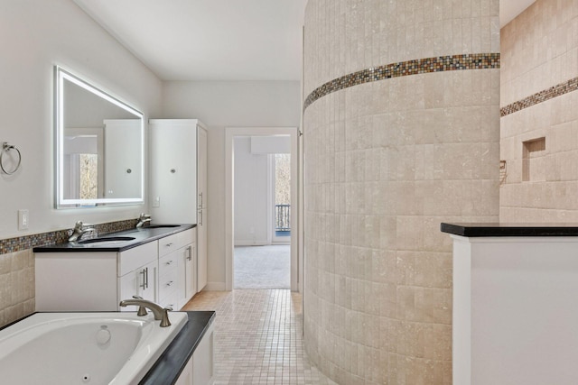 full bathroom featuring tile patterned flooring, a jetted tub, and vanity