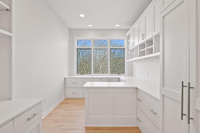 kitchen featuring open shelves, recessed lighting, light countertops, white cabinetry, and light wood-type flooring