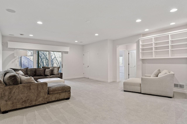 living room featuring light colored carpet, visible vents, baseboards, and recessed lighting