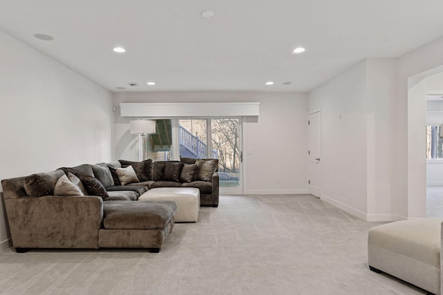 living room with baseboards, recessed lighting, plenty of natural light, and light colored carpet