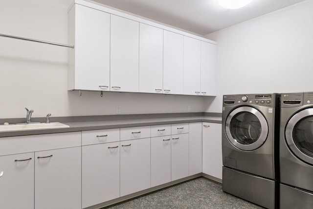 laundry room featuring cabinet space, separate washer and dryer, and a sink