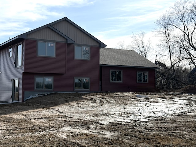 rear view of property with a shingled roof