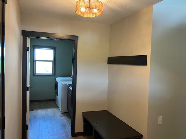 laundry room featuring wood finished floors, washing machine and dryer, and laundry area