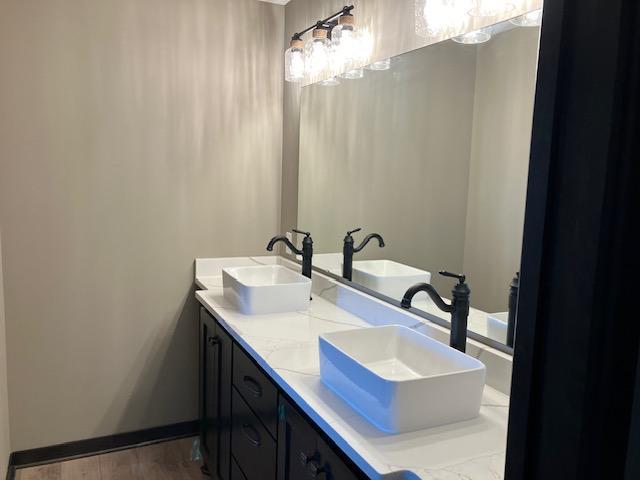 bathroom with a sink and double vanity