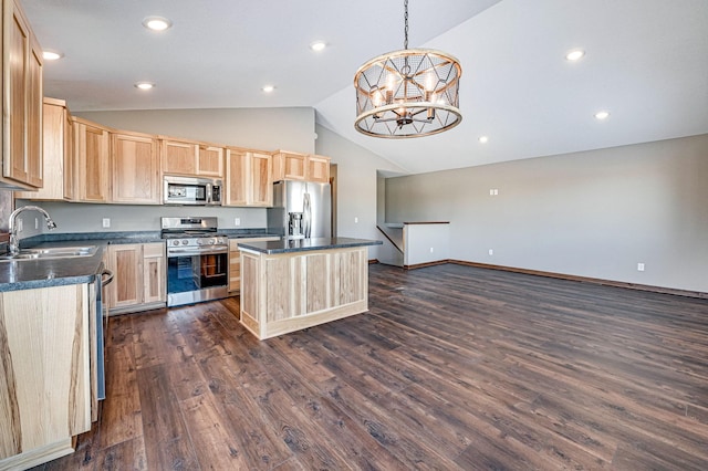 kitchen featuring an inviting chandelier, a sink, light brown cabinetry, stainless steel appliances, and dark countertops