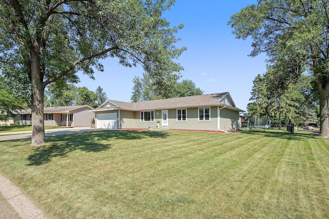 ranch-style house with a garage, a front lawn, a trampoline, and driveway