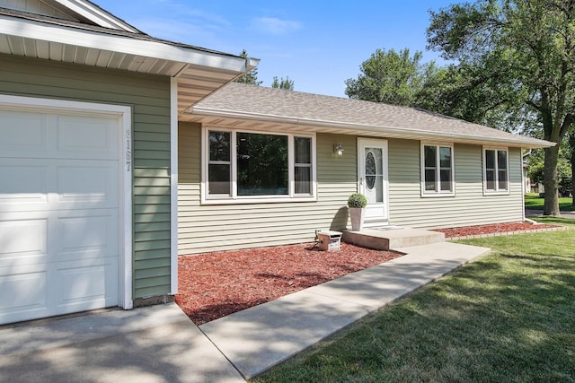 ranch-style house featuring a garage, a front lawn, and a shingled roof