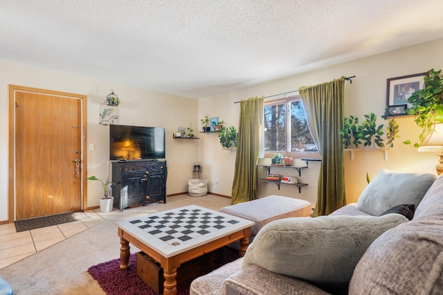 tiled living area with a textured ceiling, carpet, and baseboards