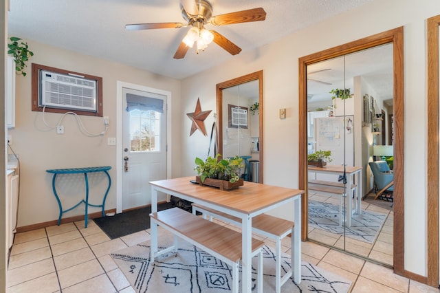 interior space featuring a wall mounted AC, ceiling fan, a textured ceiling, and light tile patterned floors