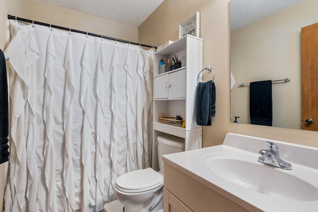 full bathroom with curtained shower, a textured ceiling, toilet, and vanity