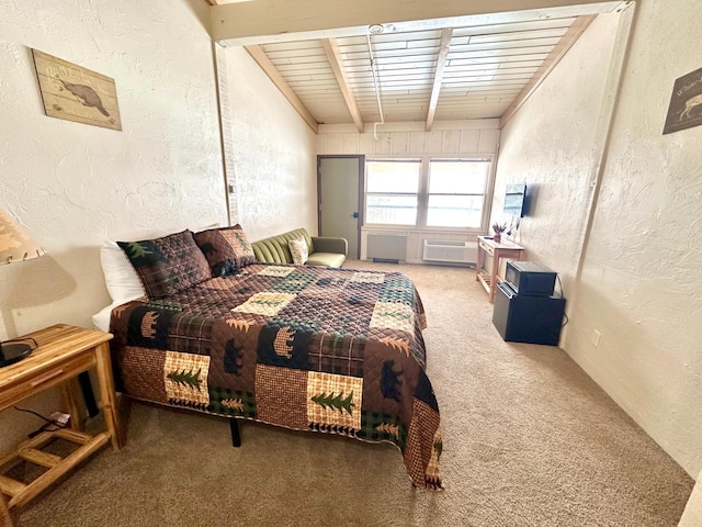 bedroom with carpet, beam ceiling, and a textured wall