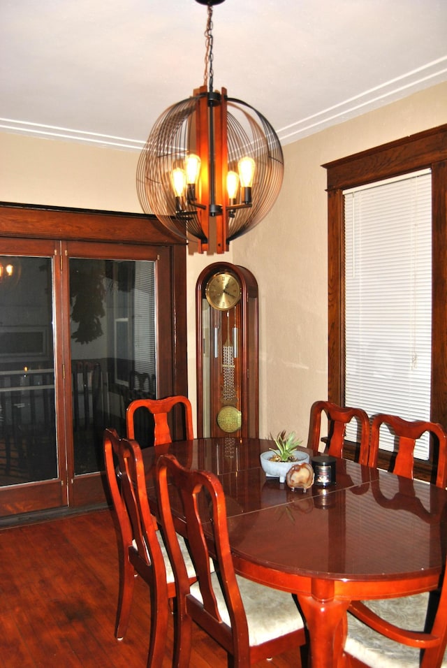 dining room featuring wood finished floors and a notable chandelier