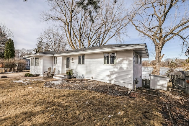 ranch-style home with a patio area and fence