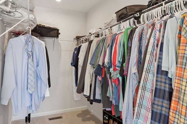 walk in closet featuring visible vents and carpet flooring