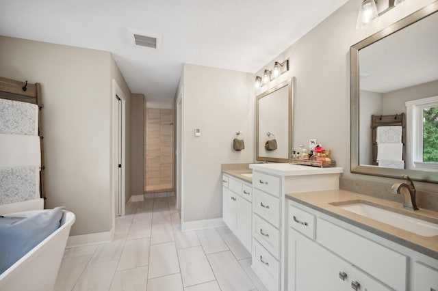 bathroom featuring two vanities, a sink, visible vents, baseboards, and a soaking tub