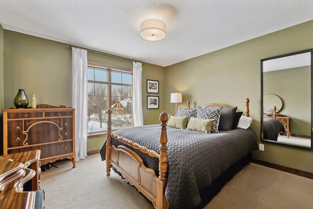 bedroom with light colored carpet, a textured ceiling, and baseboards