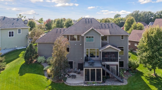 rear view of house featuring a lawn, a sunroom, stairs, a wooden deck, and a patio area