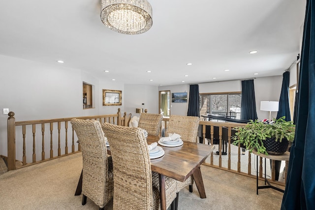 dining space featuring a chandelier, recessed lighting, and light carpet