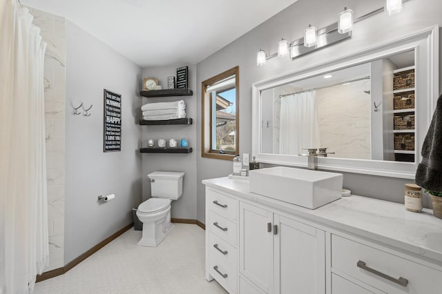 bathroom featuring toilet, curtained shower, vanity, and baseboards