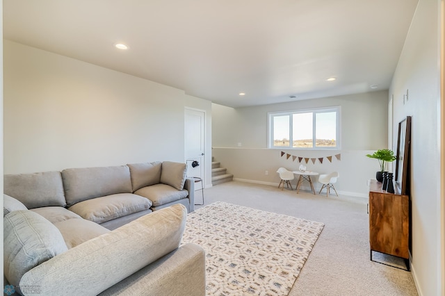 living area featuring recessed lighting, stairs, baseboards, and light colored carpet