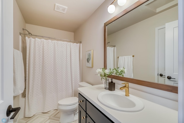 full bath featuring toilet, vanity, and visible vents