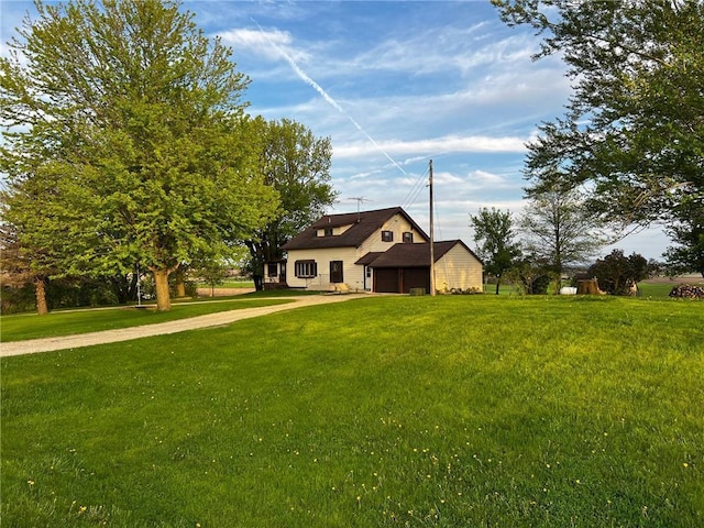 view of front of home with a front yard and concrete driveway