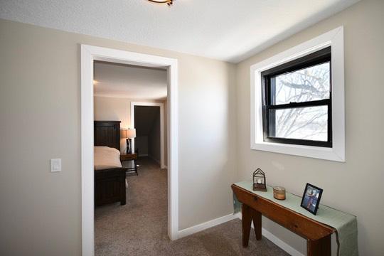 corridor with baseboards and carpet