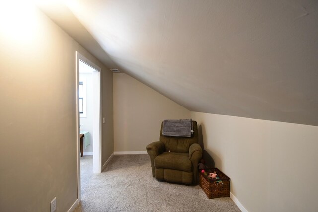 unfurnished room featuring vaulted ceiling, carpet flooring, and baseboards