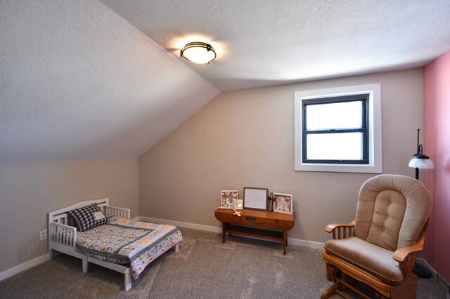carpeted bedroom featuring vaulted ceiling, baseboards, and a textured ceiling