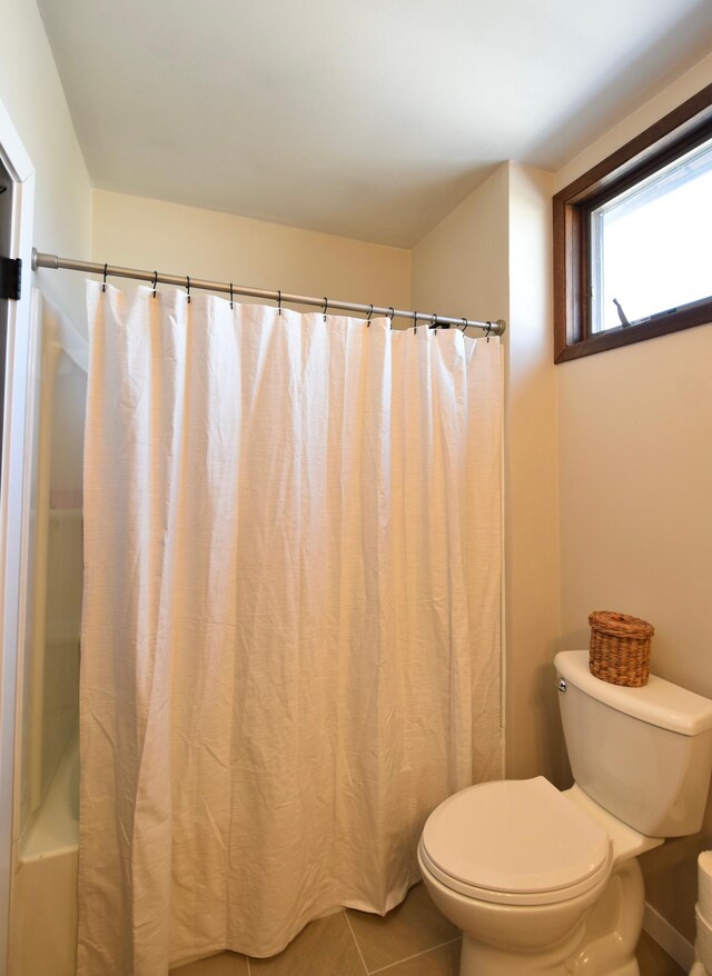 bathroom featuring tile patterned flooring and toilet