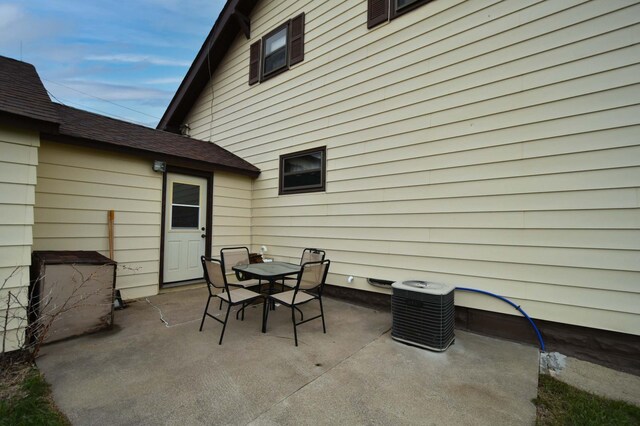 view of patio with outdoor dining space and central AC unit