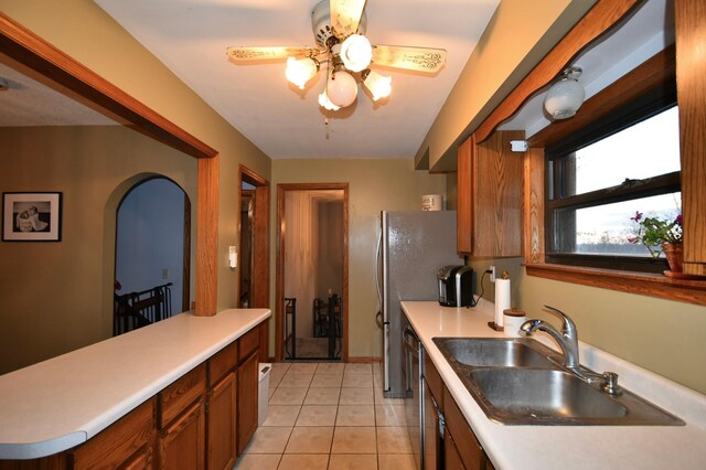 kitchen featuring a ceiling fan, a sink, and light countertops