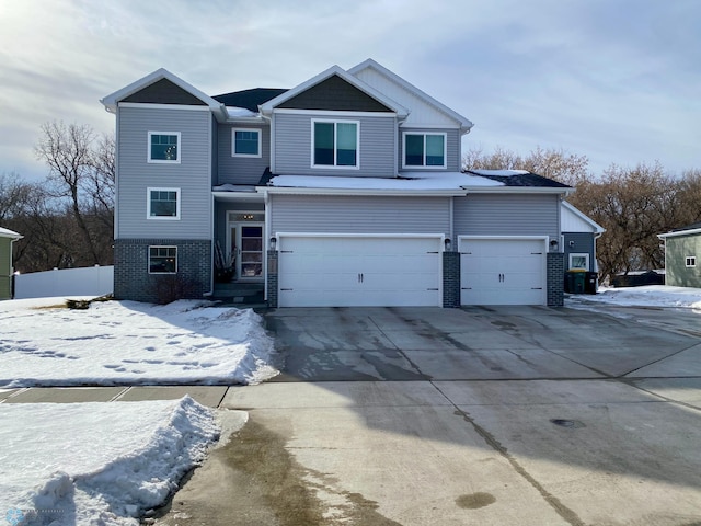 view of front of home with brick siding, central AC, fence, a garage, and driveway