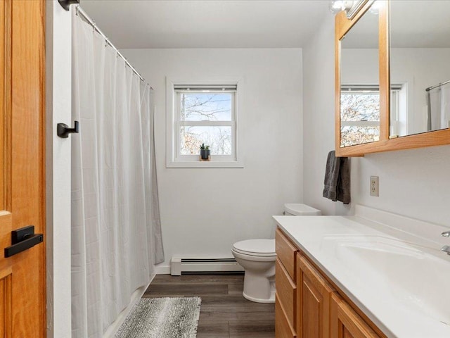 full bath with a baseboard heating unit, toilet, wood finished floors, curtained shower, and vanity
