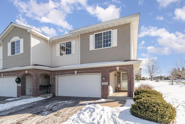 view of front of property with a garage and brick siding