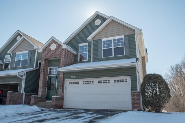 view of front of property featuring brick siding and an attached garage