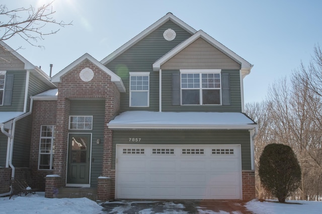 view of front of house with a garage and brick siding