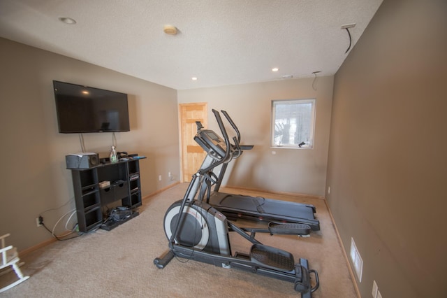 exercise room featuring carpet, baseboards, a textured ceiling, and recessed lighting