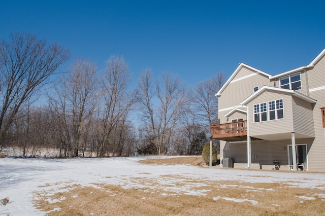 view of snow covered back of property